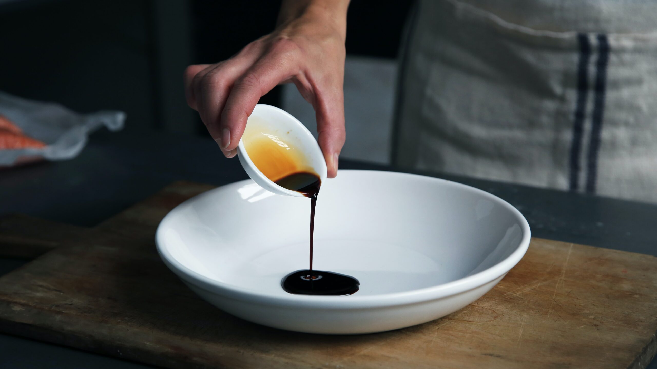 Dark sauce being pours into a plate