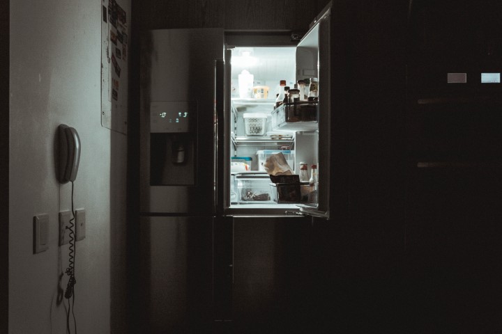 Fridge with an open door in the dark
