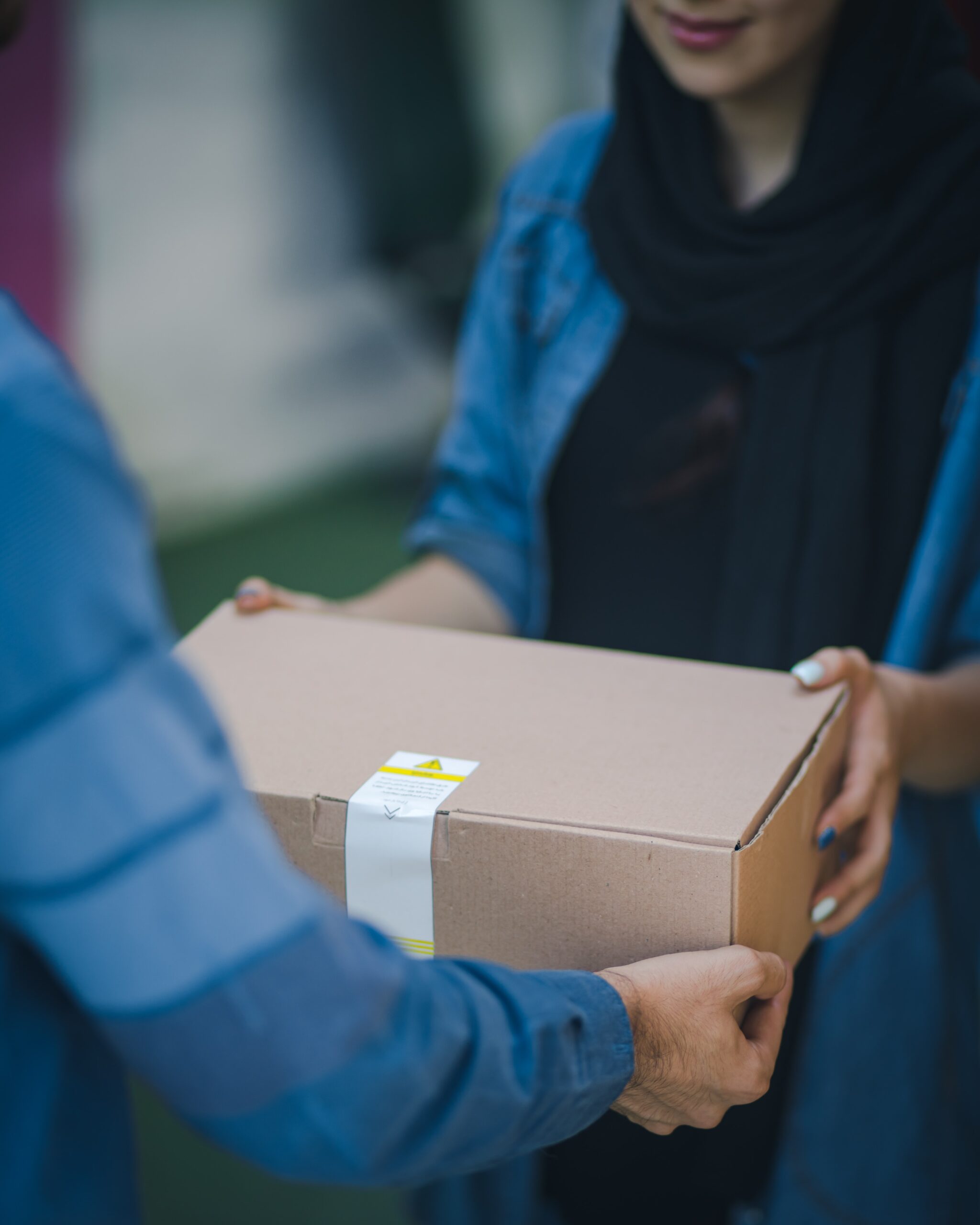 Someone handing a box to someone else.