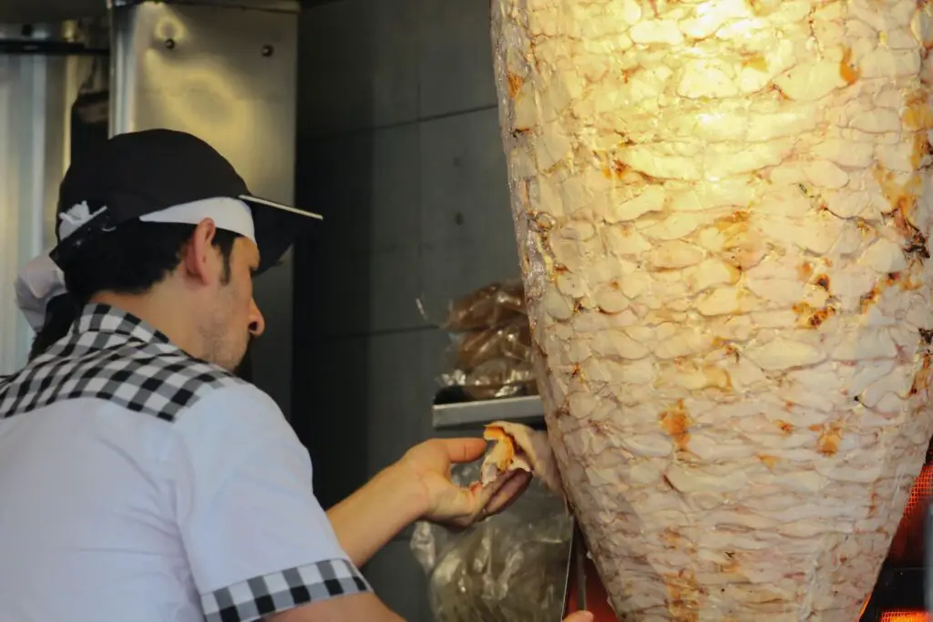 Chef cutting a very big shawarma