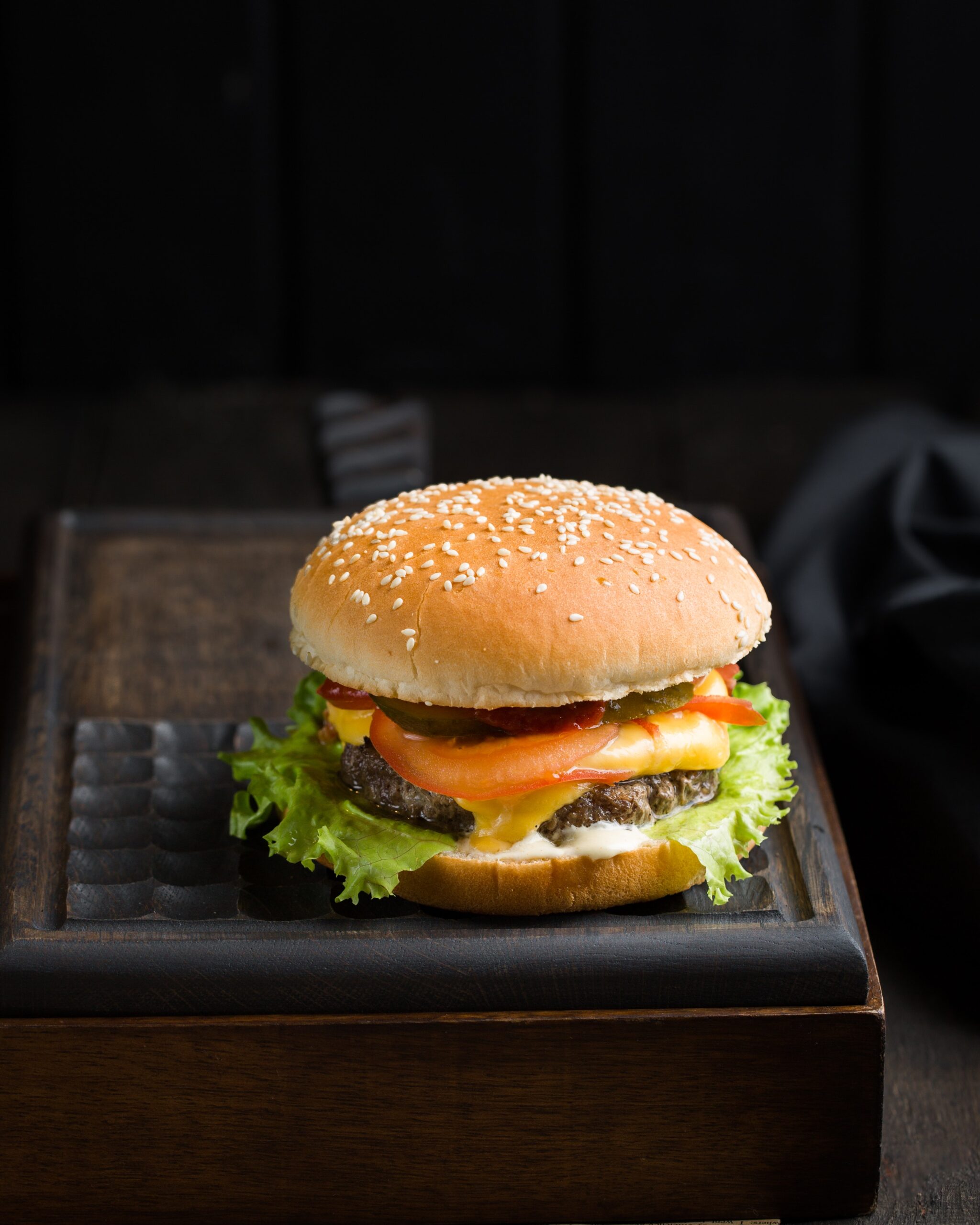 burger on a wooden board