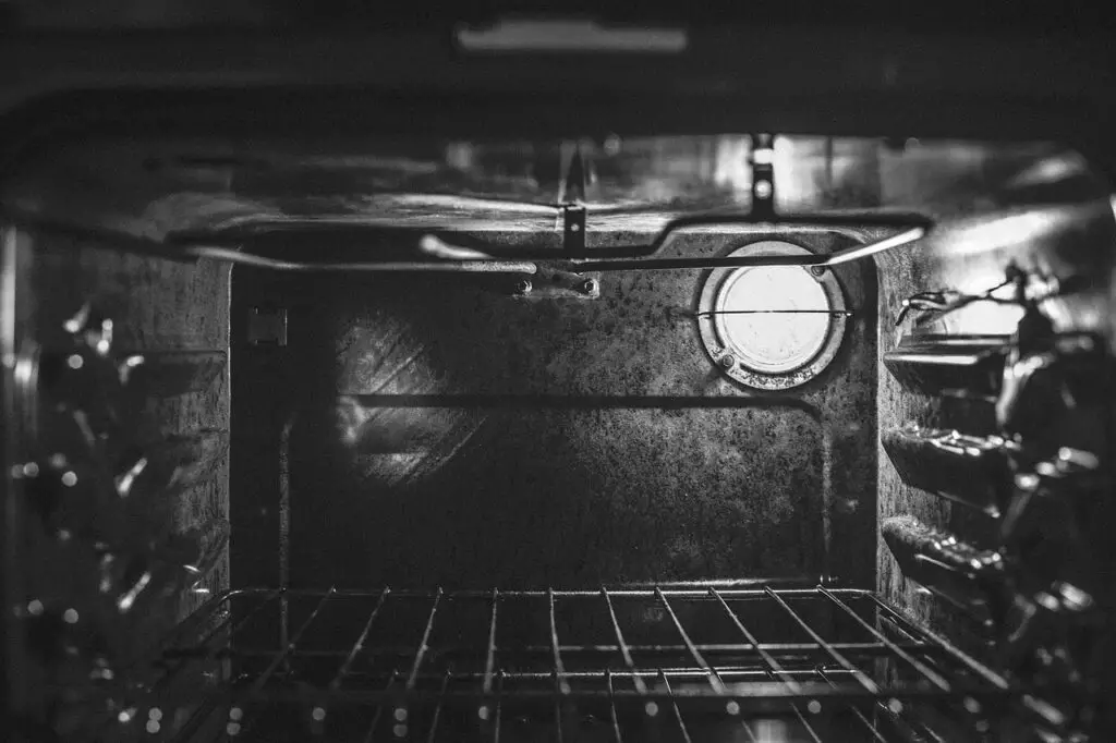 Open oven focusing on the light bulb with contrast
